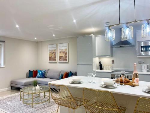 a kitchen and living room with a table and chairs at Stylish Urban Escape Cardiff Bay Free Parking in Cardiff