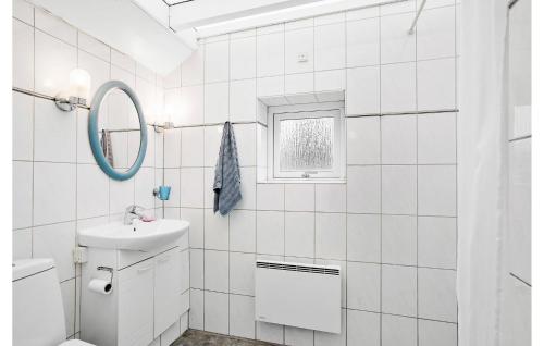a white bathroom with a sink and a mirror at Cozy Home In Hundested With Kitchen in Hundested