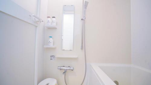 y baño con ducha, aseo y lavamanos. en TOKYO SHINJUKU MIO HOTEL, en Tokio