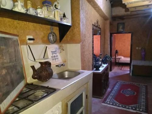 a kitchen with a sink and a stove at Riad assriir in Tiznit