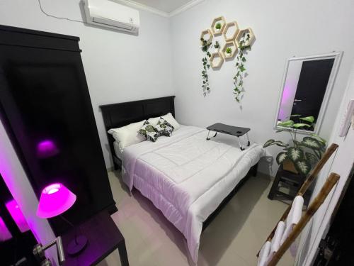 a bedroom with a bed with a laptop on it at Chandra's House in Denpasar