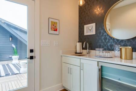 a bathroom with a sink and a mirror at The Taylors - Grand Getaway for 22 in Germantown in Nashville