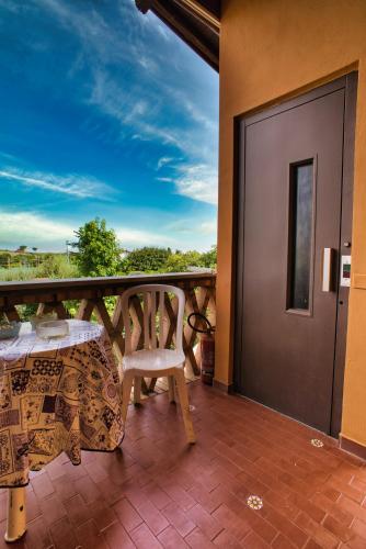a patio with a table and a chair on a balcony at B&B Casale Ansamagi Relax & Pool in Genzano di Roma