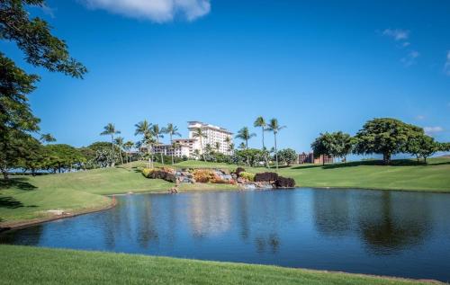 a view of a golf course with a pond at Ko Olina Beach Villas O1004 in Kapolei