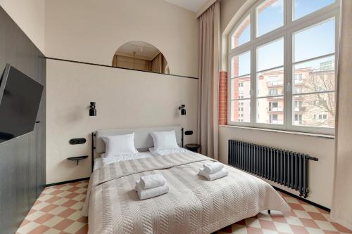 a bedroom with a large bed and a large window at Waterlane Vintage - Fitness & Gym by Blue Mandarin in Gdańsk