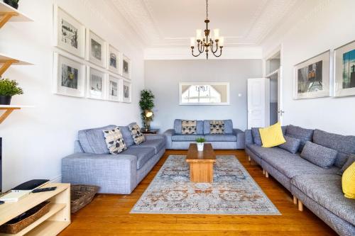 a living room with blue couches and a table at Rato by Central Hill Apartments in Lisbon