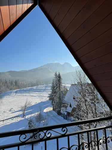 a view from the balcony of a house in the snow at Bacówka Na Bundówkach in Zakopane