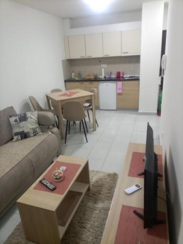 a living room with a couch and a table at JelaLux in Gornja Toplica