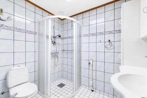 a white bathroom with a shower and a toilet at Fantastic apartment in Oslo in Oslo