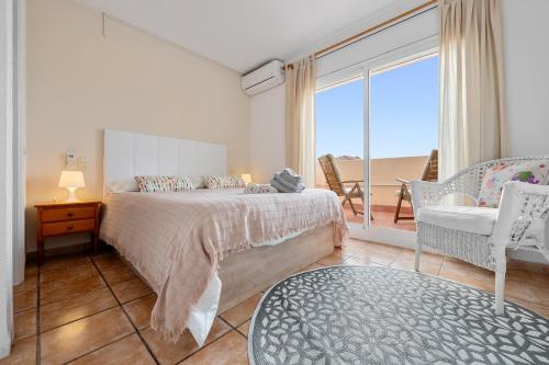 a bedroom with a bed and a view of the ocean at Can Lucia in Miami Platja