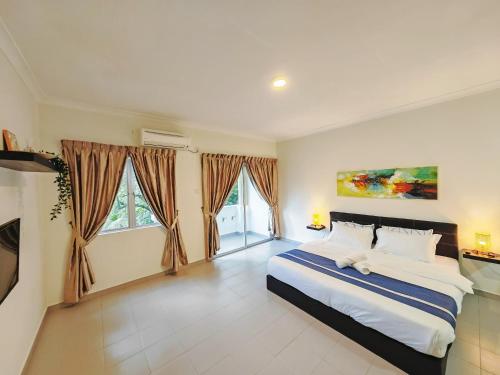 a bedroom with a large bed and a large window at Desaru Black Beach Sky Mirror Resort in Desaru
