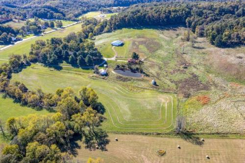 an aerial view of a large field with a house at Whole House 85 Acre Private Ranch Sleeps 8, hot-tub king beds in Logan