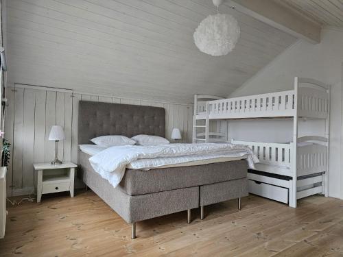 a bedroom with a large bed with white furniture at Idylliskt Hus Nära Lysekil & Skaftö in Uddevalla