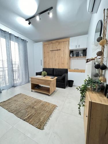 a living room with a couch and a coffee table at Olympus! Athens! Studio in the Sky!! 20' walk to the Acropolis in Athens