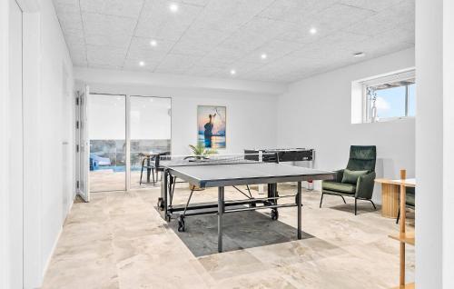 a dining room with a ping pong table and two chairs at Stunning Home In Løgstrup With Kitchen in Løgstrup
