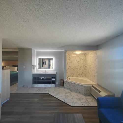 a large bathroom with a tub and a sink at Mountain Vista Inn & Suites - Walking Distance to the Island in Pigeon Forge