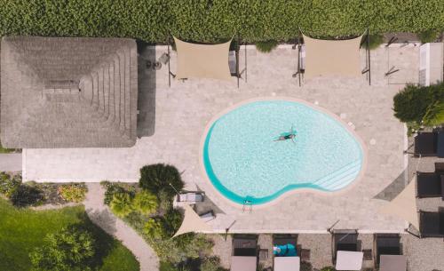 an overhead view of a swimming pool in a resort at Is Cheas wine farm boutique hotel in San Vero Milis