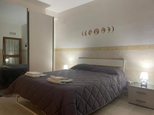 een slaapkamer met een bed en een grote spiegel bij La Dependance in Barletta