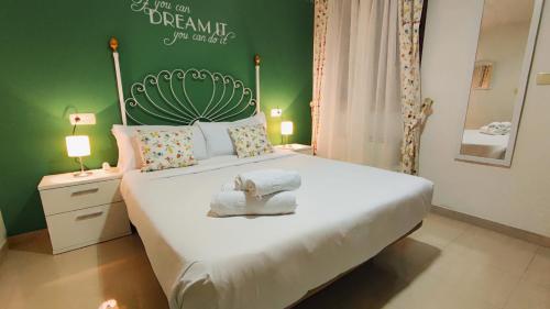 a bedroom with a large bed with a green wall at Casa BRAIS in Barreiros