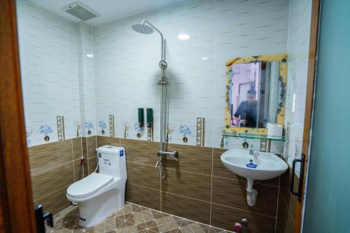 a bathroom with a toilet and a sink at The Sun Long Hai Hotel in Long Hai