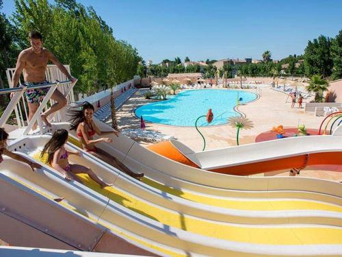 a group of people on a water slide at a resort at camping les sables du midi in Valras-Plage