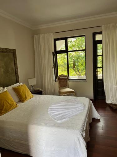 a bedroom with a large white bed and two windows at Boutique Hotel Akvilla in Sarigerme