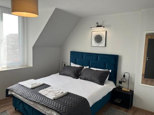 a bed with a blue headboard in a bedroom at Mimsy house in Plovdiv