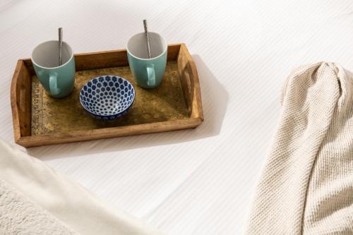 a tray with three cups on top of a table at Dreamwood - Woodland Cottage with Private Hot Tub in Blandford Forum