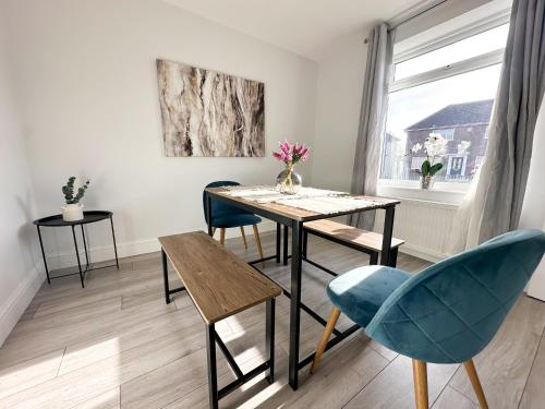 a dining room with a table and chairs and a window at York House by Blue Skies Stays in Stockton-on-Tees
