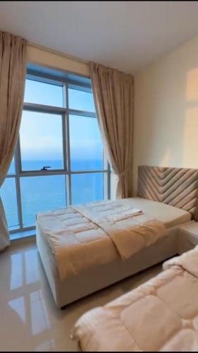 a bedroom with a bed and a large window at عجمان in Ajman 