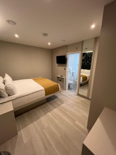 a bedroom with a bed and a television in it at Hendon Studios in The Hyde