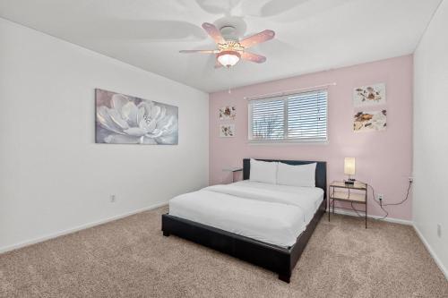 a bedroom with a bed and a ceiling fan at 1130 Mockingbird St in Brighton