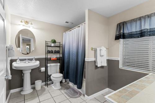 a bathroom with a sink and a toilet and a shower at 1130 Mockingbird St in Brighton