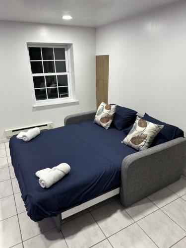 a bed with two pillows on it in a room at Pipo’s perfect place in Jersey City