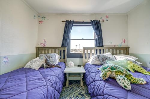 two beds sitting next to each other in a bedroom at Kill Devil Hills Condo with Beach Access On-Site! in Kill Devil Hills