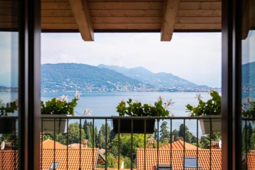 a view of a lake from a house window at Relax house Baveno in Baveno