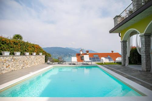 a swimming pool in front of a house at Relax house Baveno in Baveno