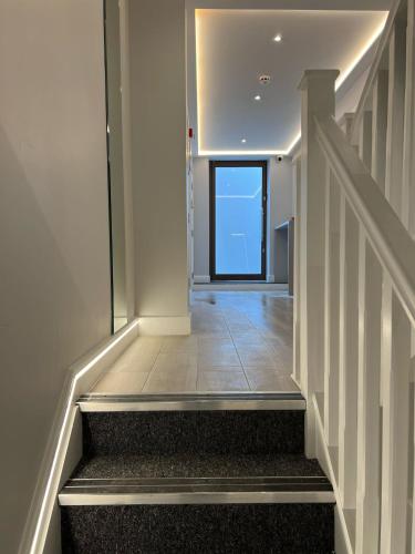 a hallway with stairs with a door in a building at Hendon Studios in The Hyde