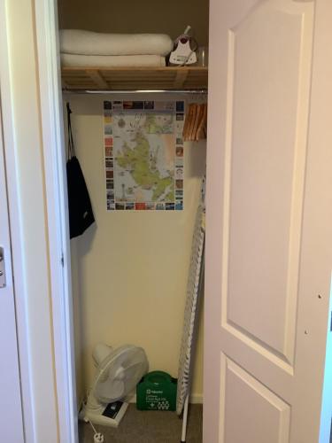 a closet with a toilet and a map on the wall at Heatherbrae Guest House in Kyle of Lochalsh