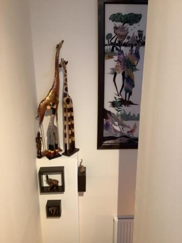a wall with two giraffe figurines on the wall at Heatherbrae Guest House in Kyle of Lochalsh
