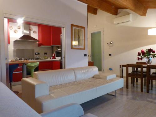 a living room with a couch and a kitchen at Alloggio turistico a Ravenna in Ravenna