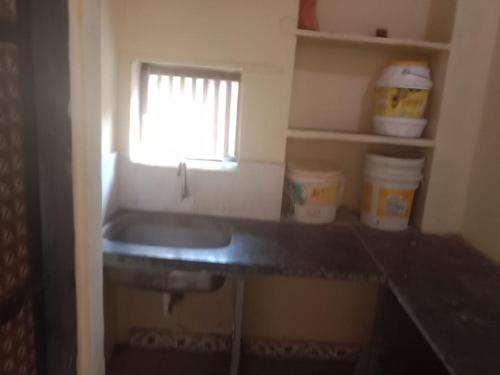 a small kitchen with a sink and a window at Om Laxmi Narayan Homestay in Diveagar