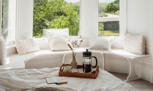 a room with a bed and a window with a coffee maker at Castle Beach in Broughty Ferry