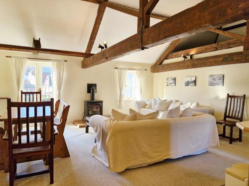 a bedroom with a large bed with white sheets at The Old Sail Loft - Emsworth in Emsworth