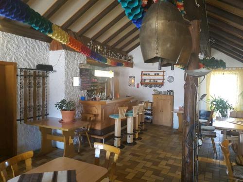 a restaurant with wooden tables and chairs and a large pot at Wolpertinger | Camping-Aach in Oberstaufen
