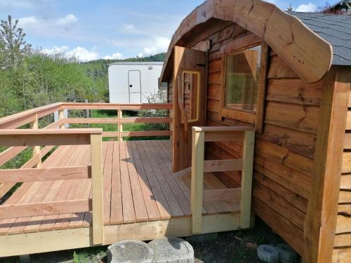 a wooden playhouse on a deck at Wolpertinger | Camping-Aach in Oberstaufen