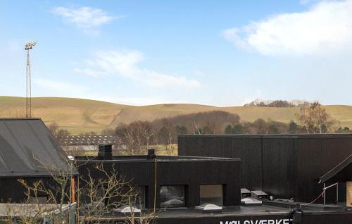 a black building with hills in the background at Two-Bedroom Apartment In Knebel in Knebel
