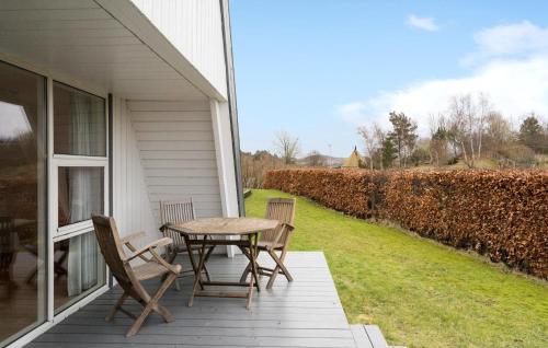 a patio with a table and chairs on a house at Two-Bedroom Apartment In Knebel in Knebel