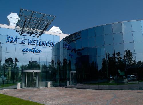 a glass building with a sign on the side of it at Glamping Terme Čatež in Brežice
