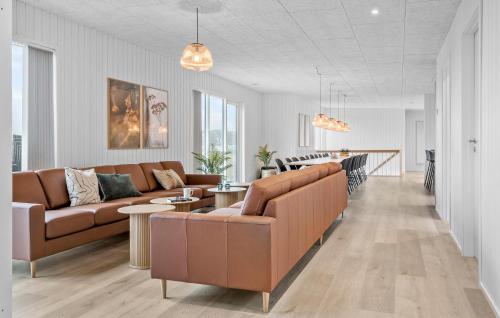 a living room with two brown couches and a table at Stunning Home In Løgstrup With Kitchen in Løgstrup